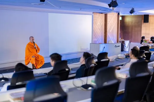 Guiding the meditation from the front of the auditorium