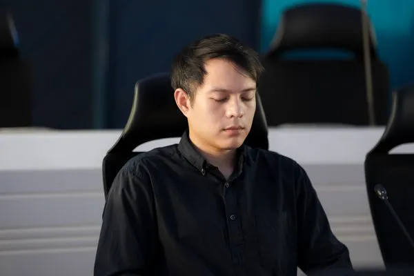 A participant meditating in his seat