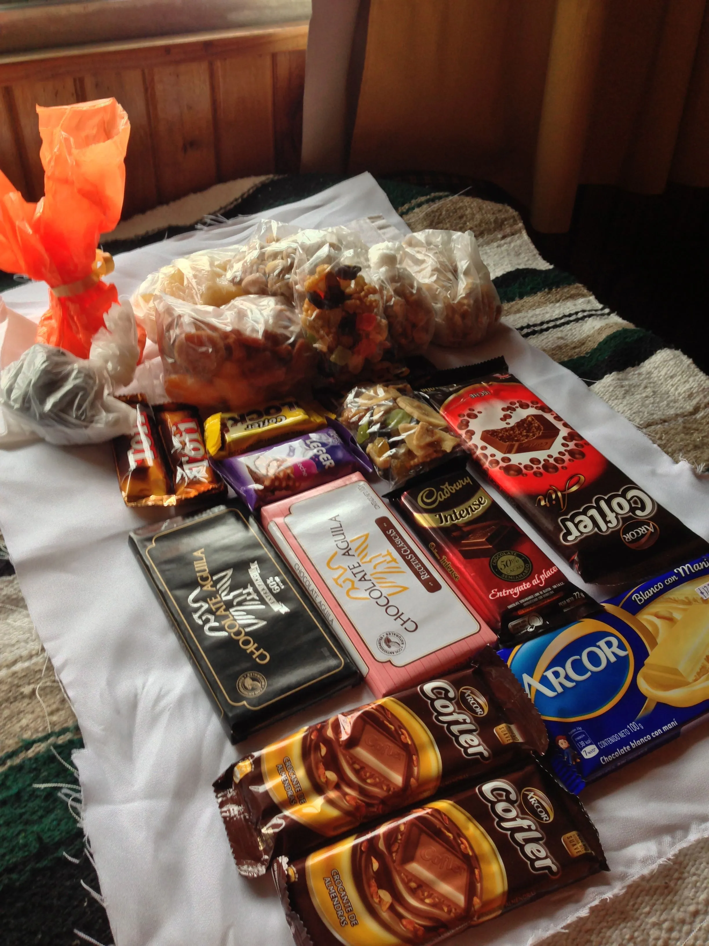 Chocolates and snacks wrapped in a white cloth offered to the monks