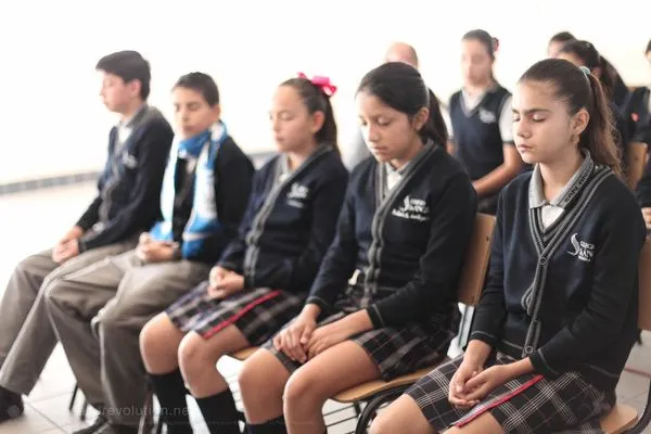 San Ángel students meditating in their school uniforms
