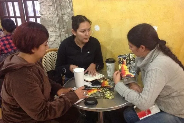 Three of the Saltillo team planning the visit with brochures on the table