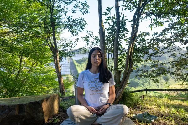 Meditating on a stone seat in the early light