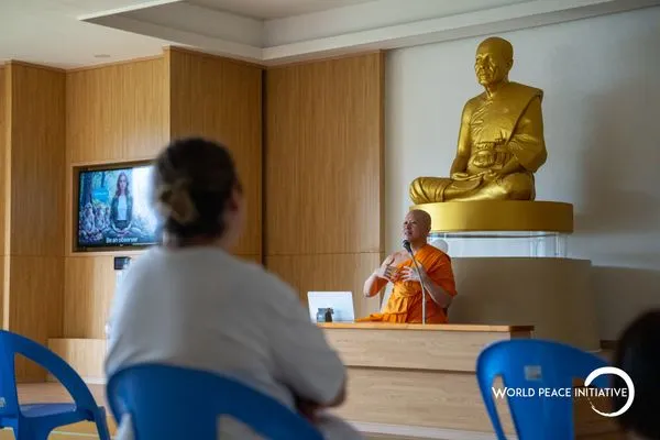 Teaching in the main hall in front of the golden monk image